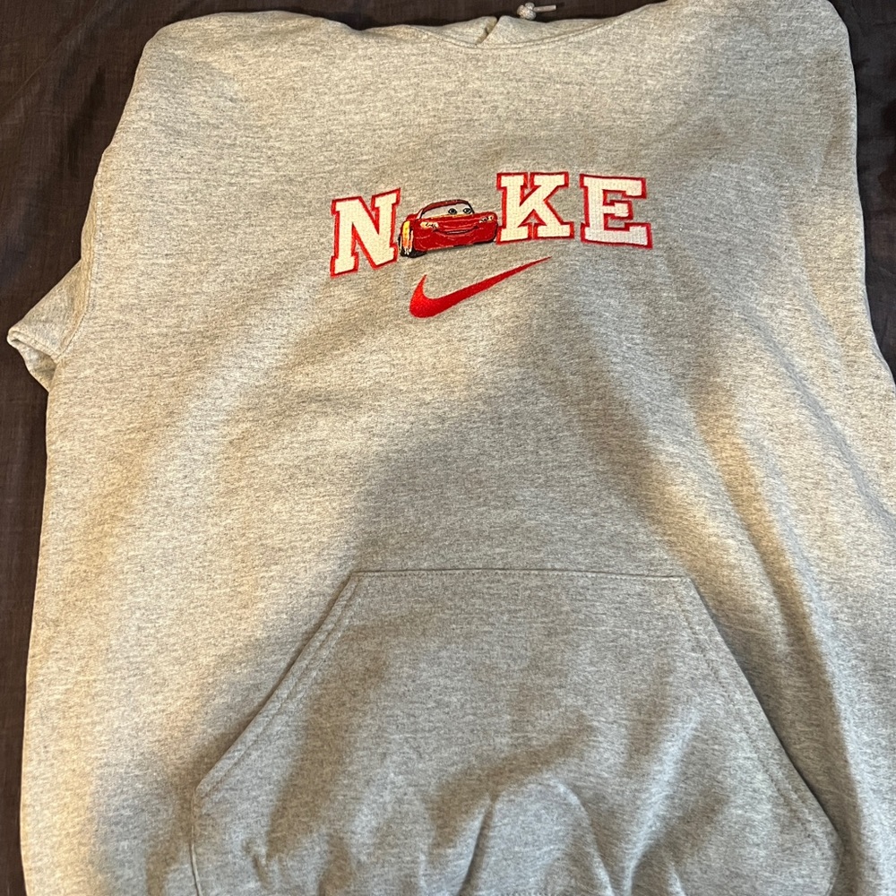 Medium men’s Nike hoodie with lighting McQueen in place of the “i”